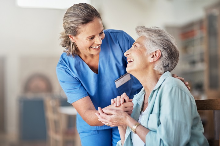 Nurse holding a PD patient's hand