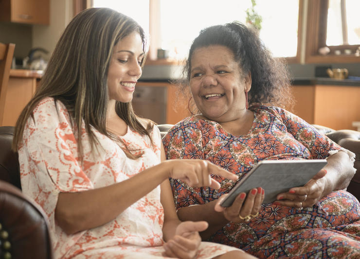 Two women talking with a tablet